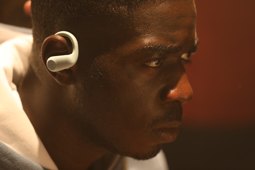 a close up of a person wearing a pair of ear buds