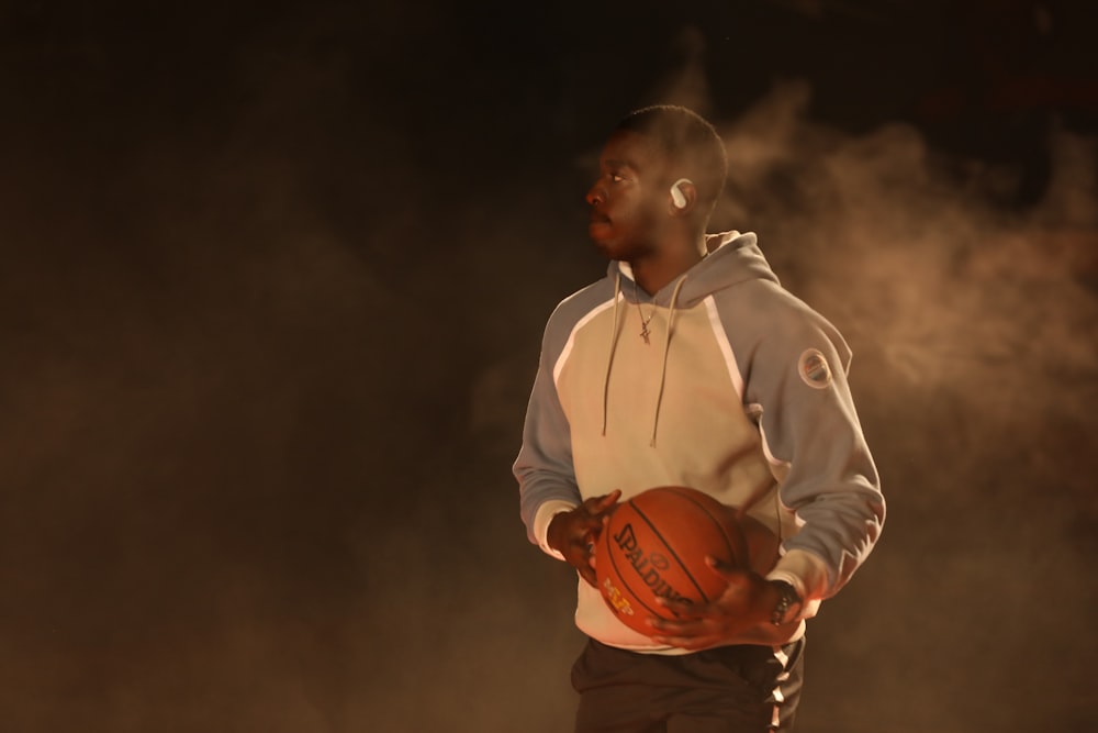 a man holding a basketball in his hands