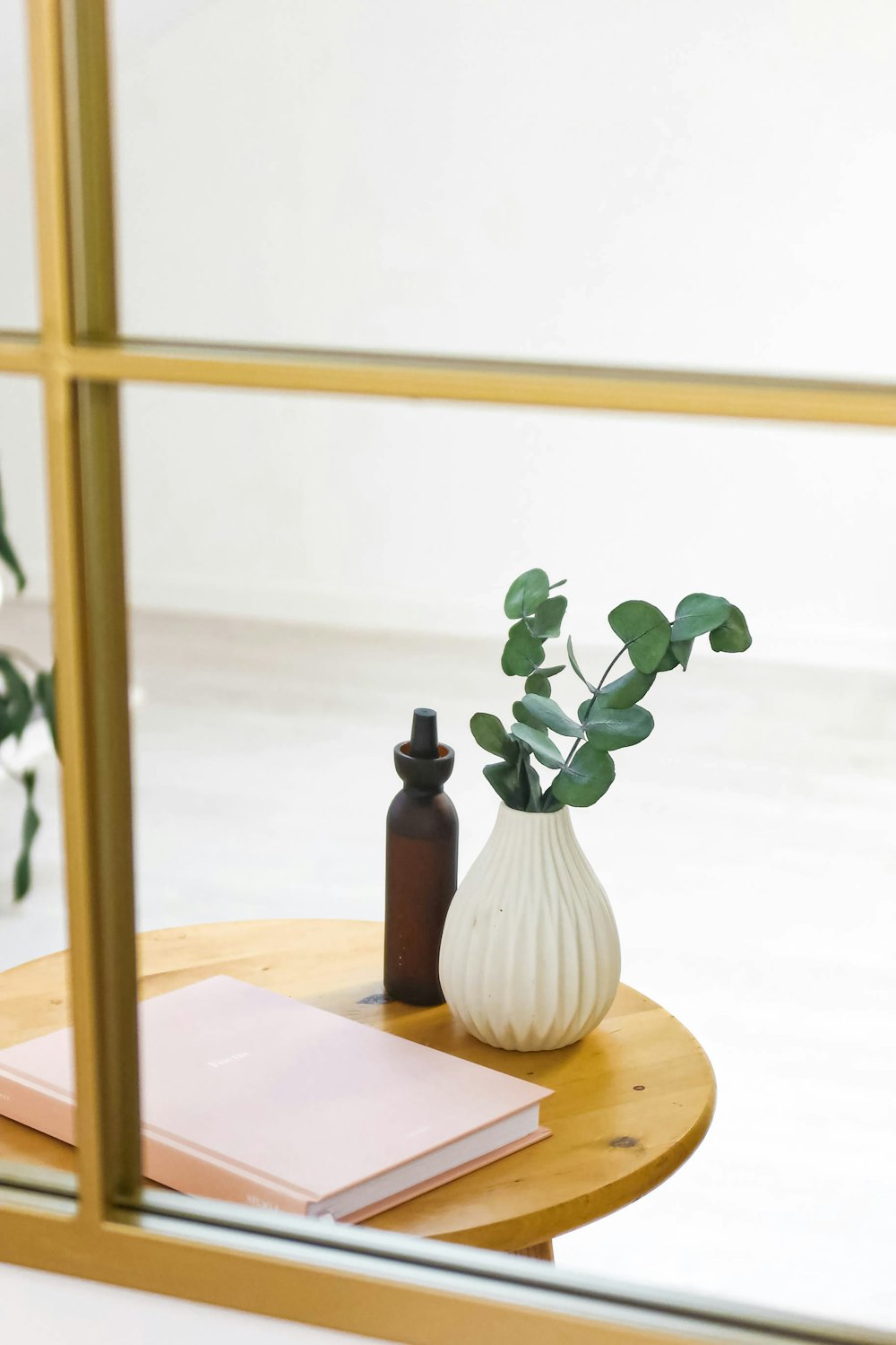 a table with a vase and a book on it