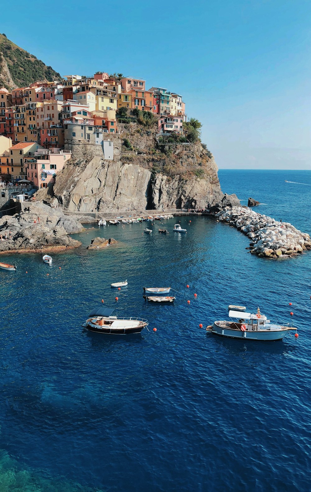 a group of boats floating on top of a body of water