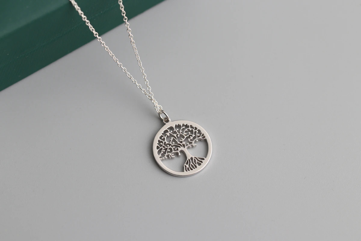Close-up of a sterling silver pendant showing the polished surface and hallmark details