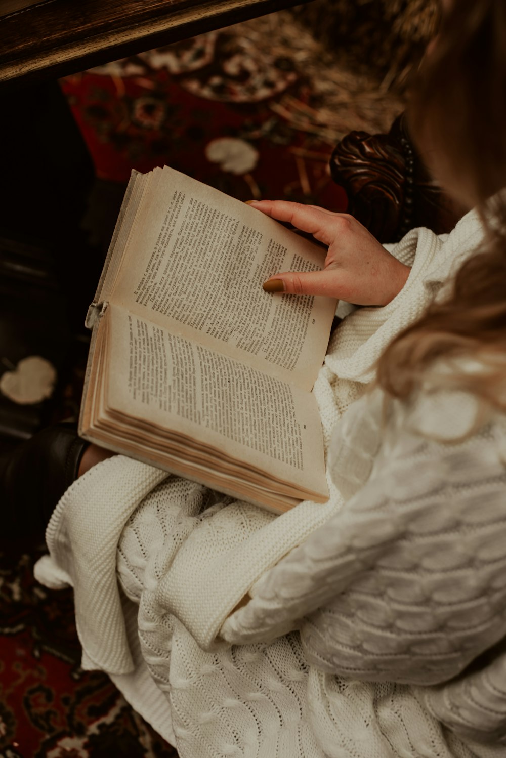 a woman lying on top of a book