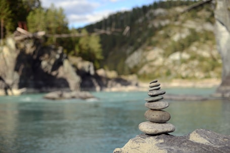 a stack of rocks sitting on top of a river