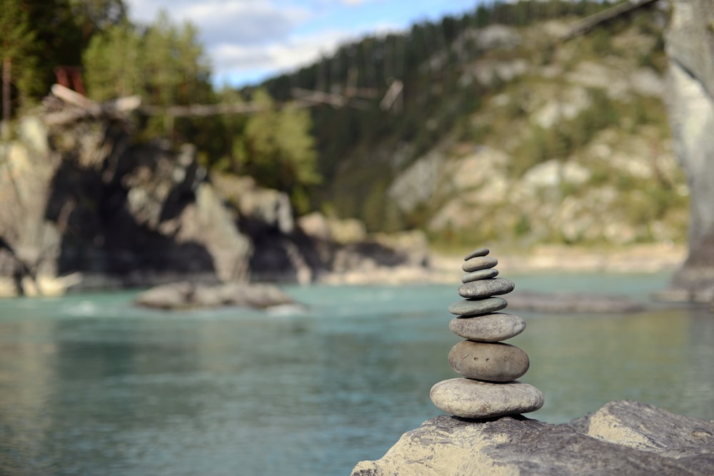 a stack of rocks sitting on top of a river