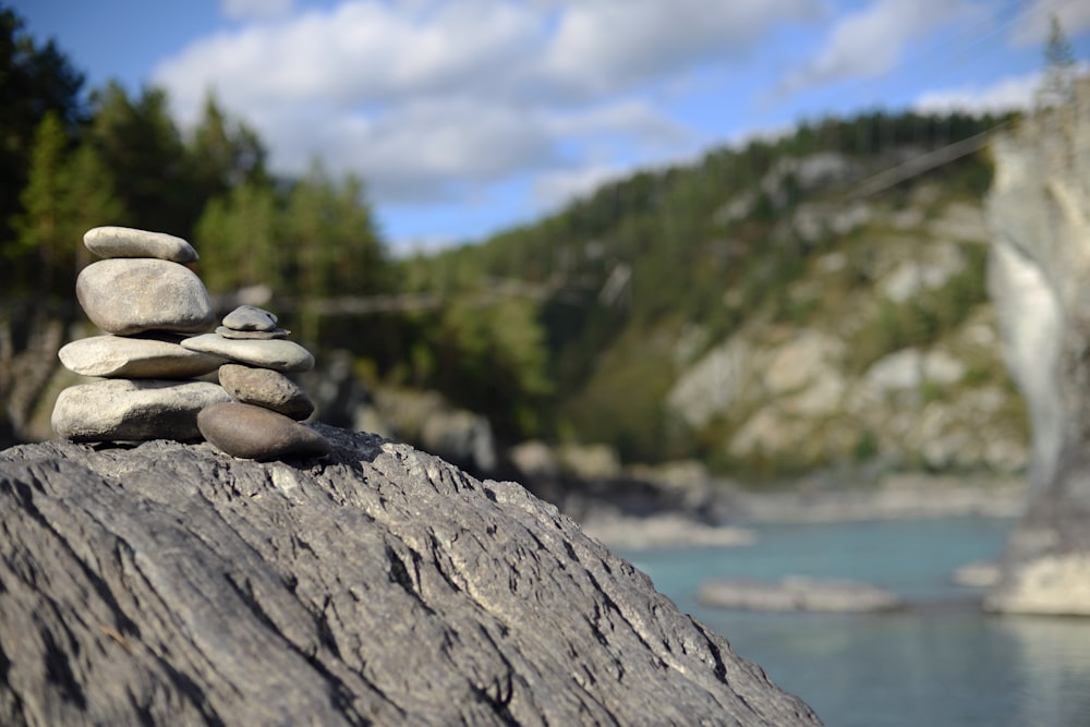 a pile of rocks sitting on top of a wooden log