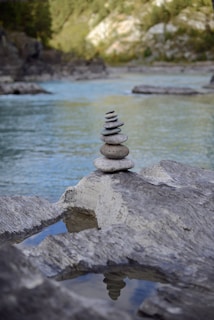 A smooth river stone balanced delicately on a stack of others.