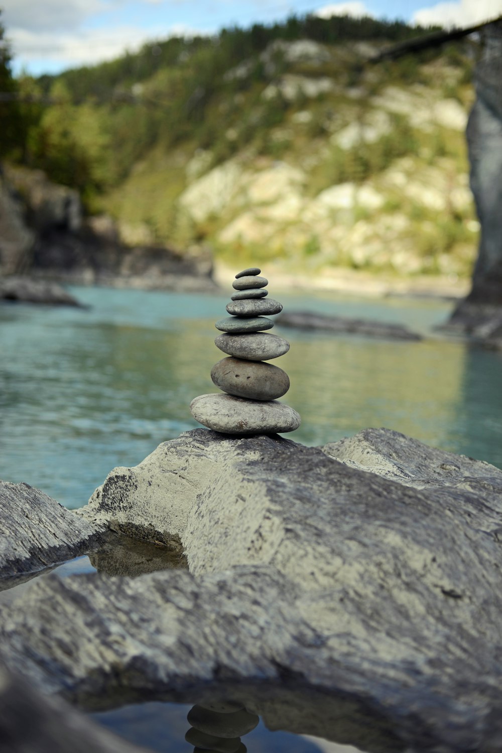 a pile of rocks sitting on top of a river