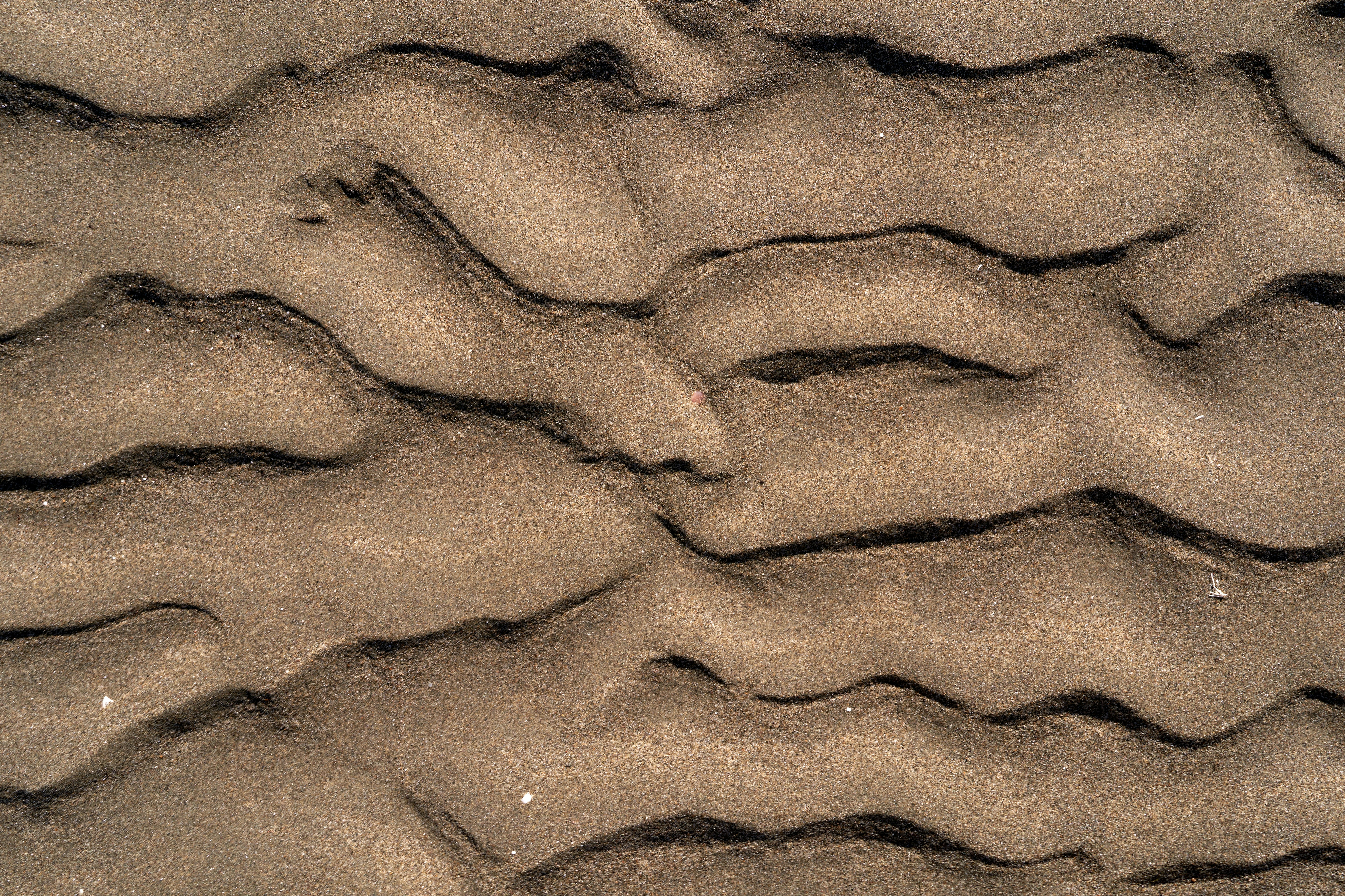 a close up of sand with wavy lines