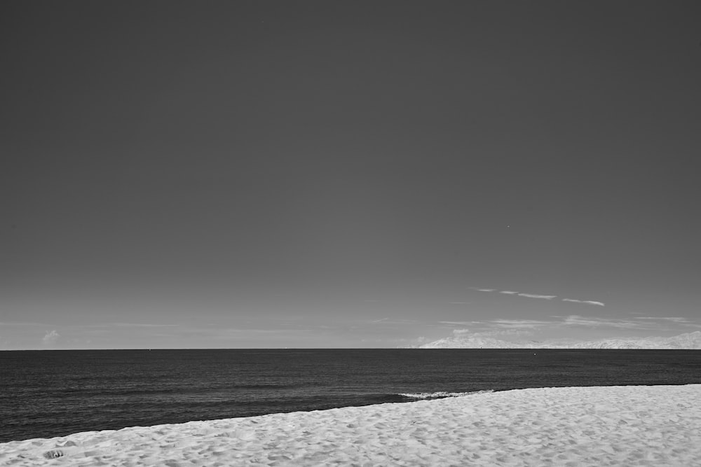 a black and white photo of a beach