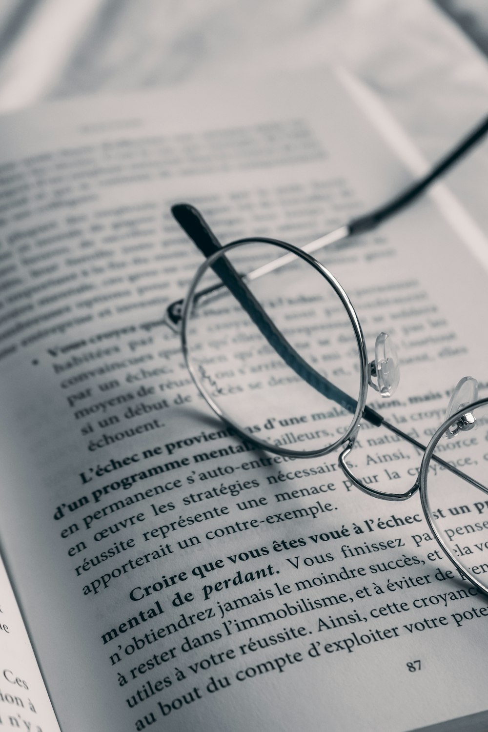 a pair of glasses sitting on top of an open book