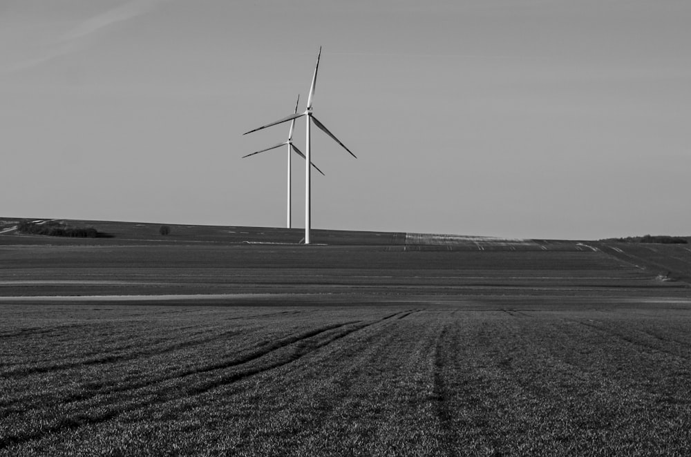 a black and white photo of a wind farm