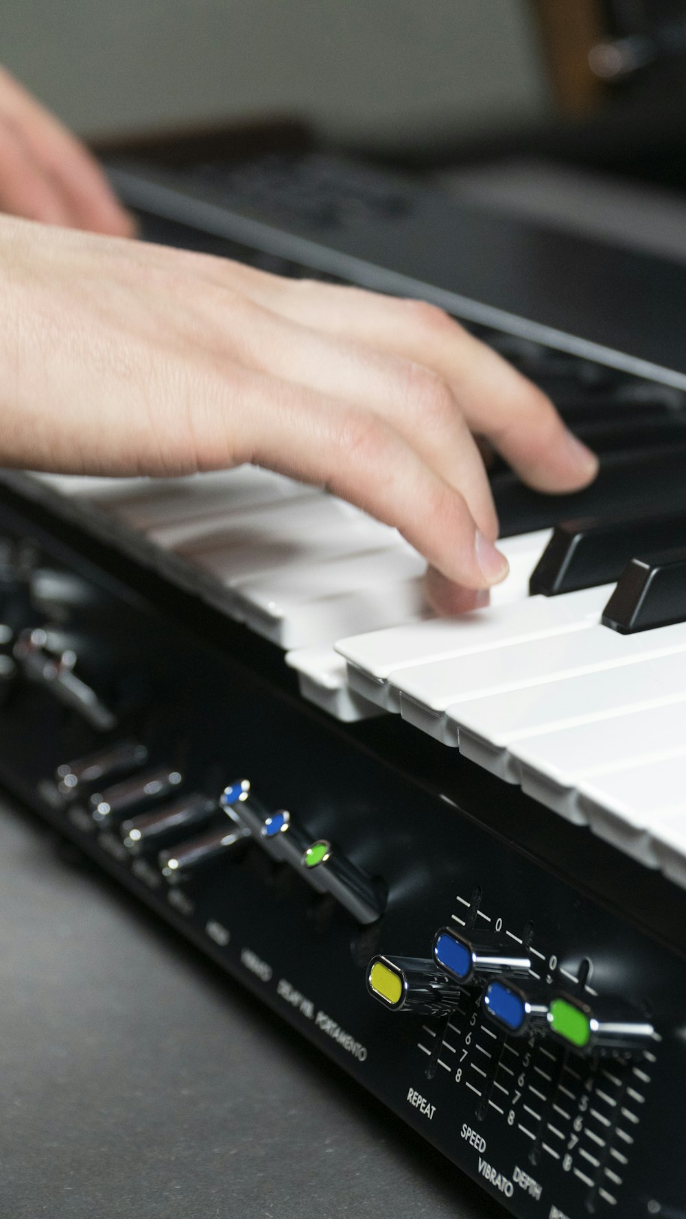 a person's hand on a piano keyboard