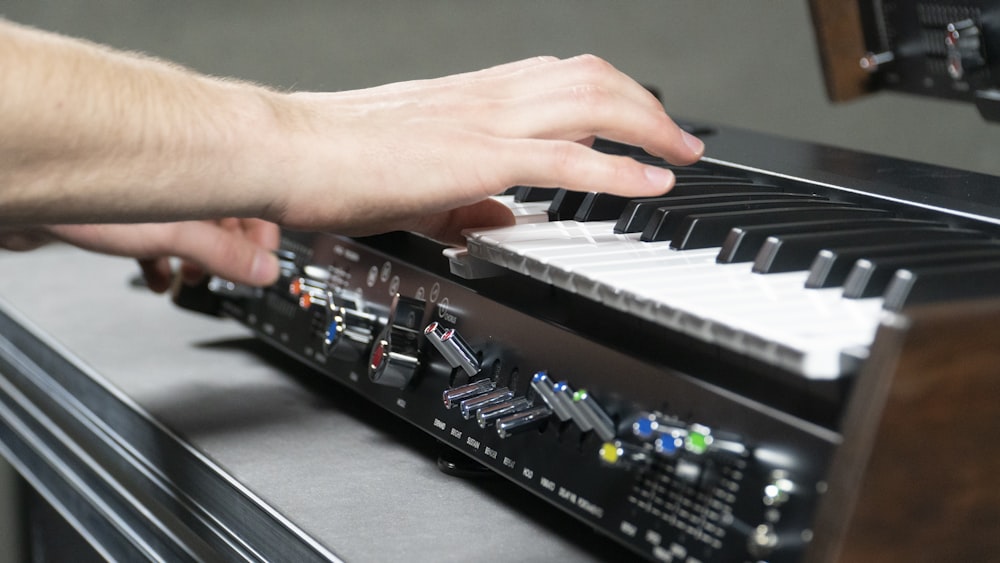 a person is playing a keyboard on a table