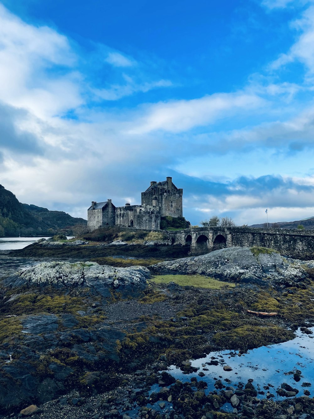 a castle sitting on top of a lush green field