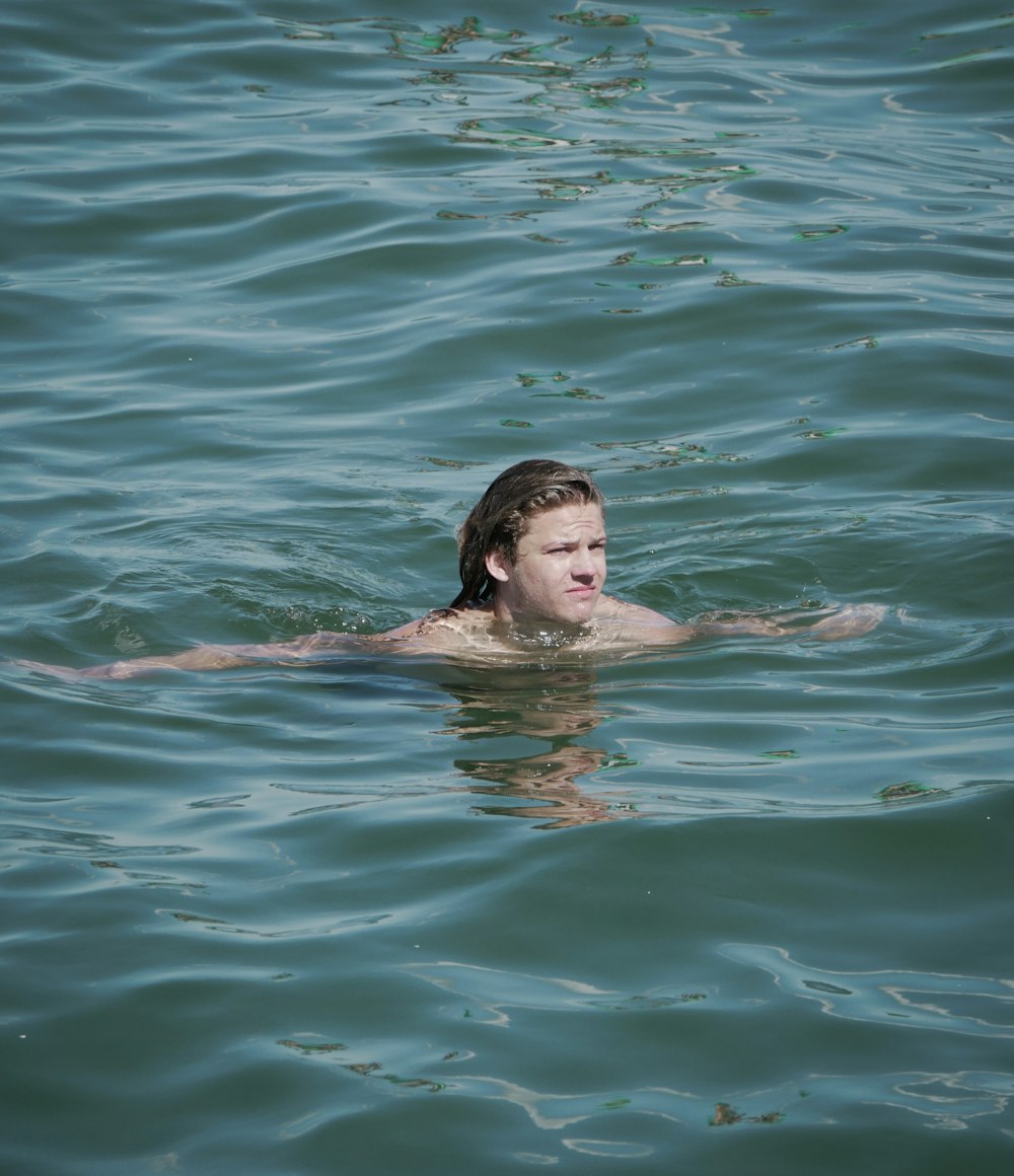 a man swimming in a body of water