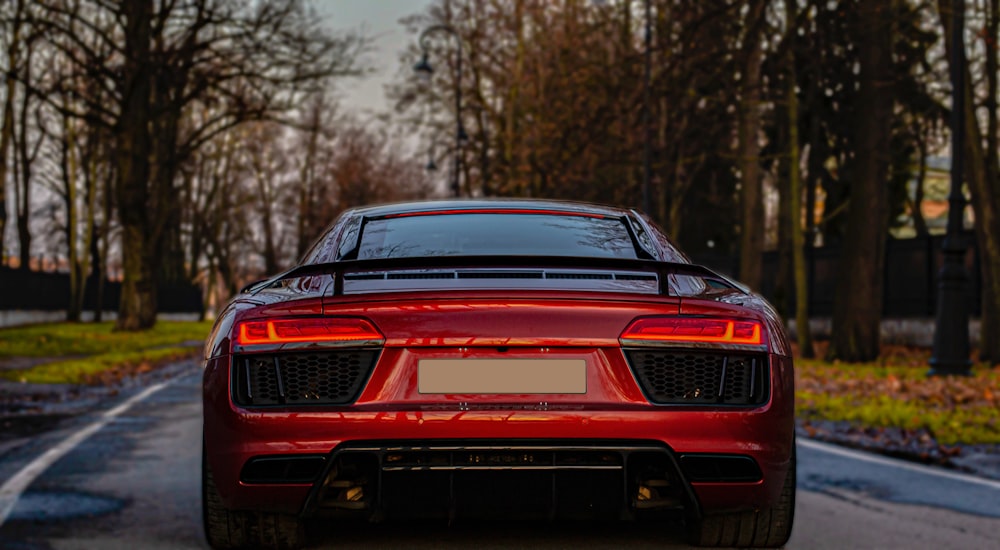 a red sports car parked on the side of the road