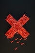 a cross made out of small pieces of red plastic