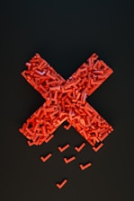 a cross made out of small pieces of red plastic
