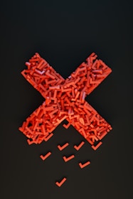 a cross made out of small pieces of red plastic