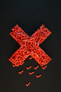 a cross made out of small pieces of red plastic