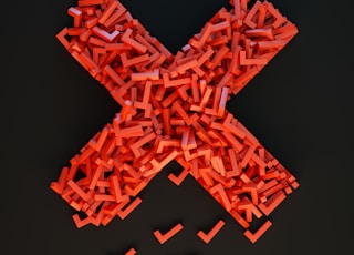 a cross made out of small pieces of red plastic