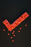 a group of red crosses on a black surface