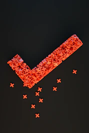 a group of red crosses on a black surface