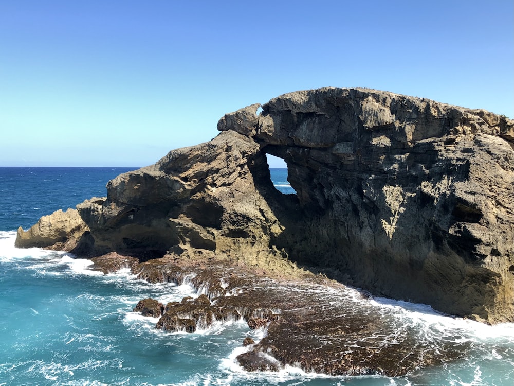 a rocky outcropping with a hole in the middle of it