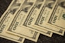 a pile of twenty dollar bills laying on top of each other