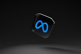 A sleek, black background with a floating glossy black square featuring a prominent blue infinity symbol.