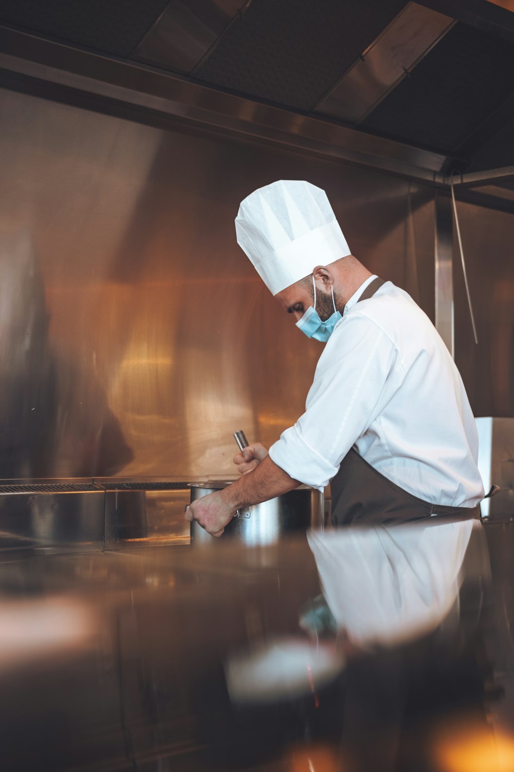 a chef writing on a clipboard in a kitchen