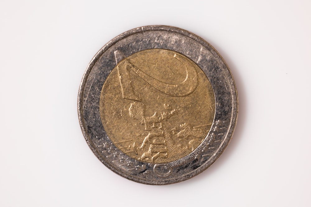 a close up of a coin on a white surface