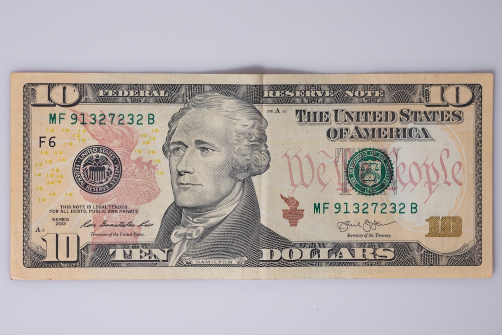 a ten dollar bill with a portrait of george washington