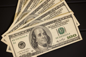 a stack of twenty dollar bills sitting on top of each other