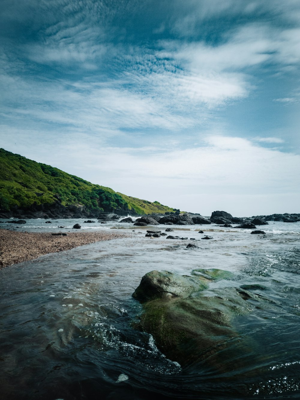 a body of water near a rocky shore