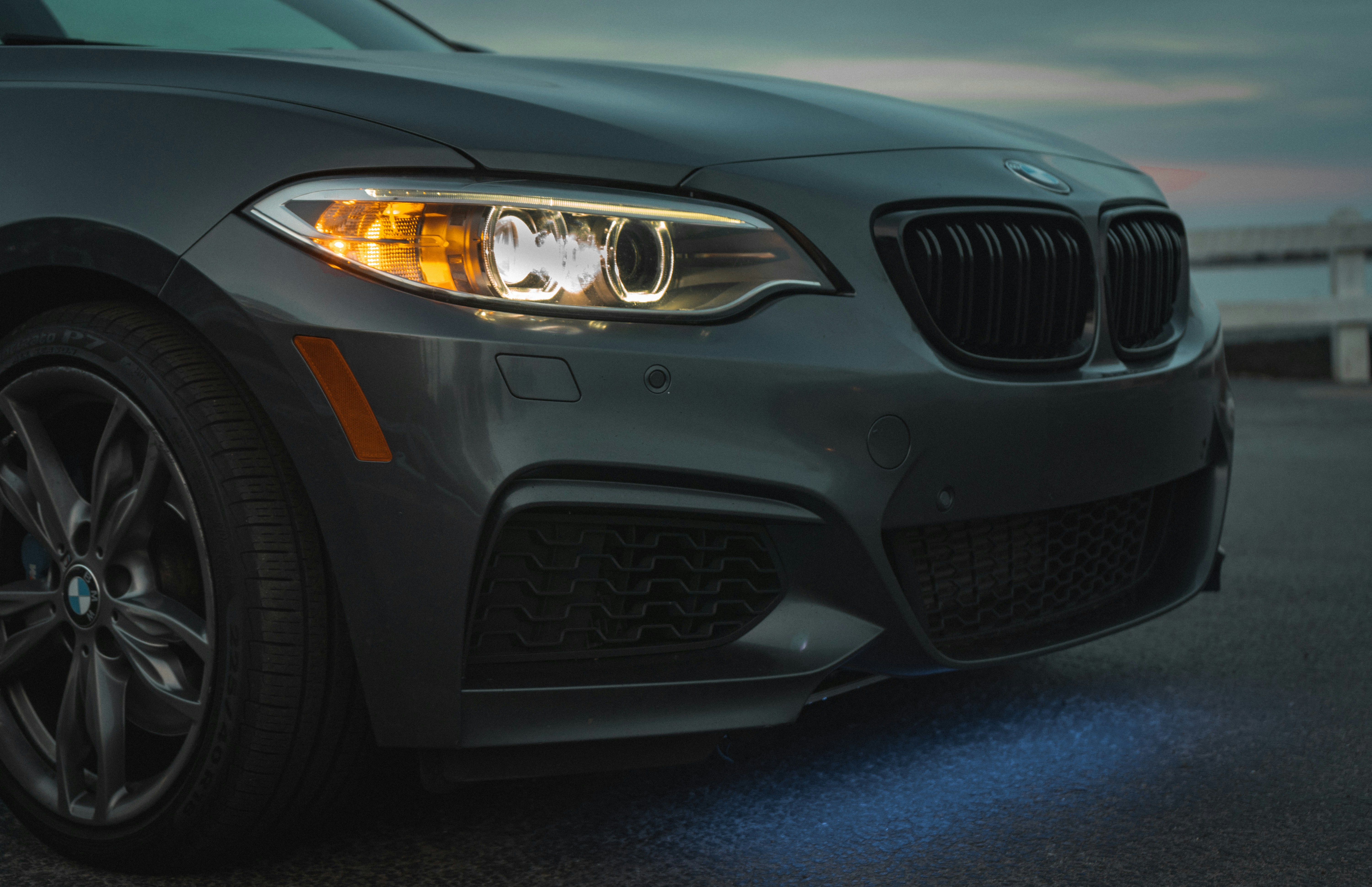 the front end of a gray bmw car