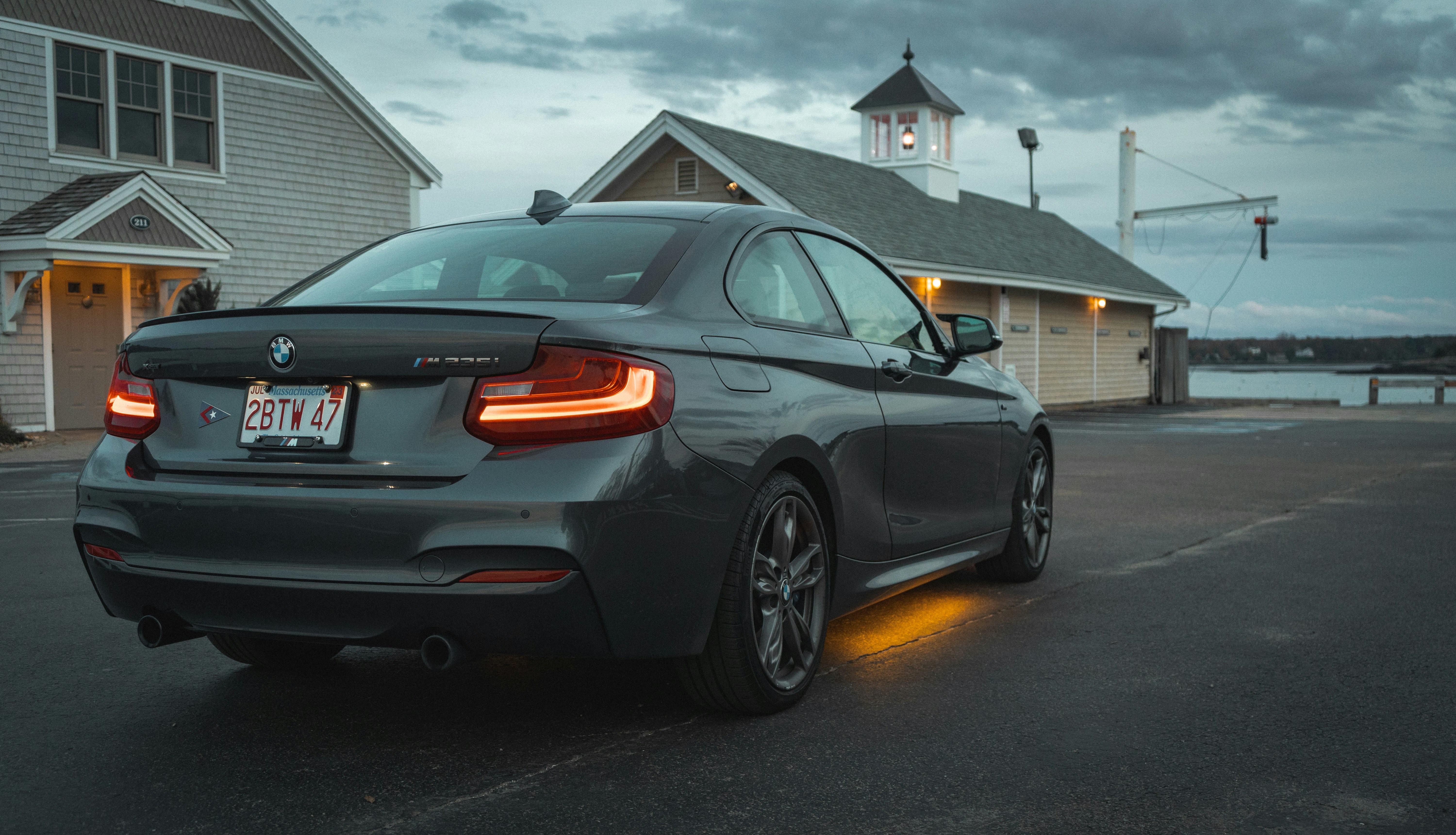 a grey car parked in front of a house