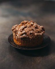 a muffin sitting on a plate on a table