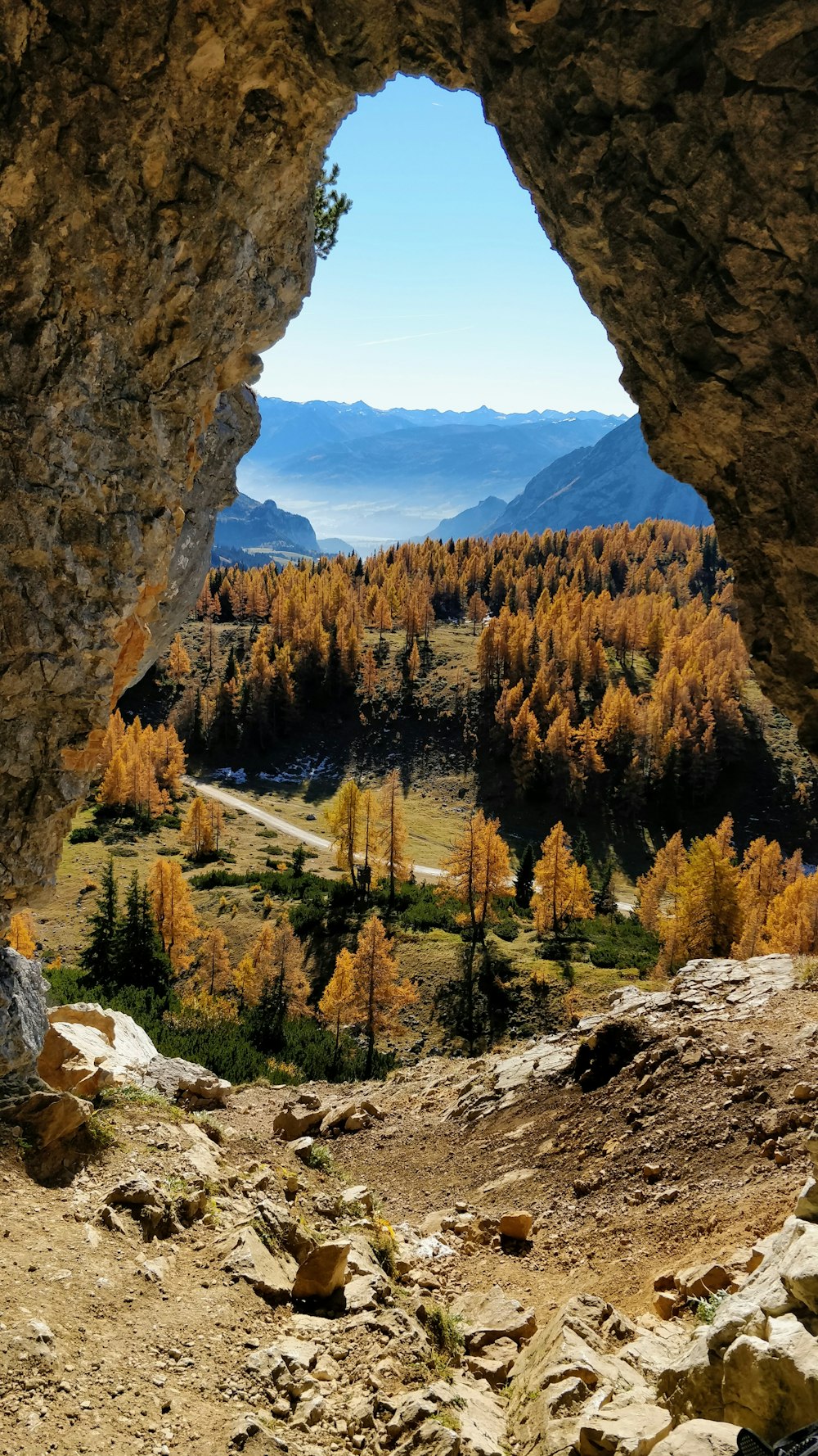 a view of a valley through a cave