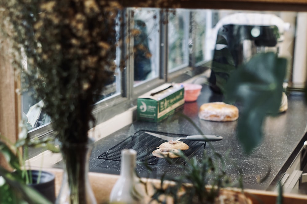 a kitchen counter with a stove top and a window