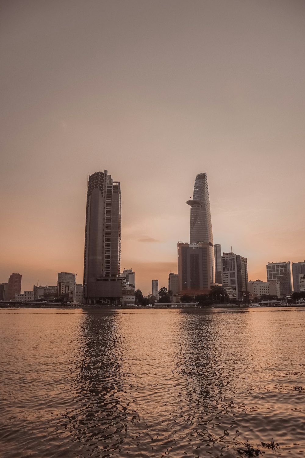 a body of water with buildings in the background