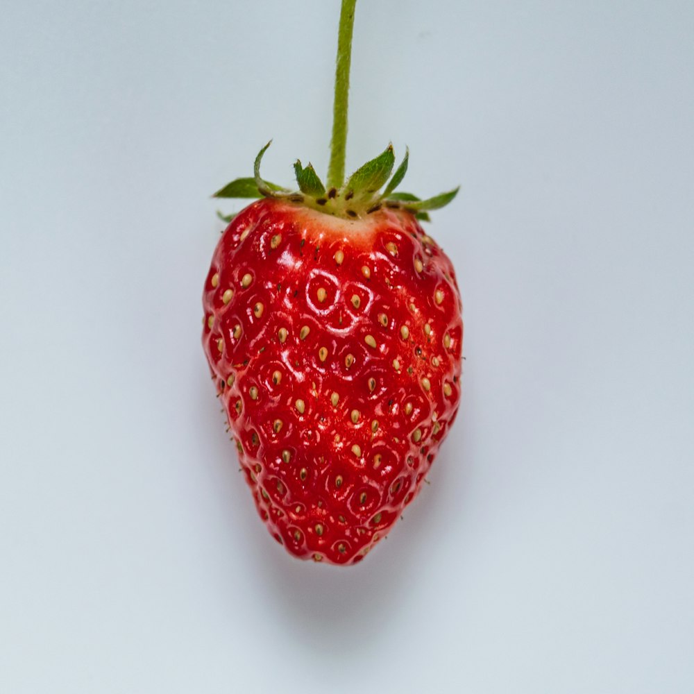 a close up of a strawberry on a white background