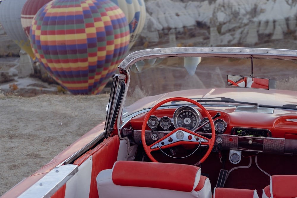 a red and white car with a steering wheel