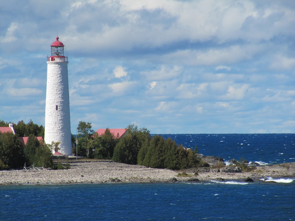 a lighthouse on a small island in the middle of the ocean