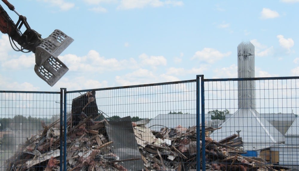 a pile of rubble sitting next to a fence