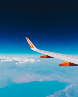 a view of the wing of an airplane in the sky