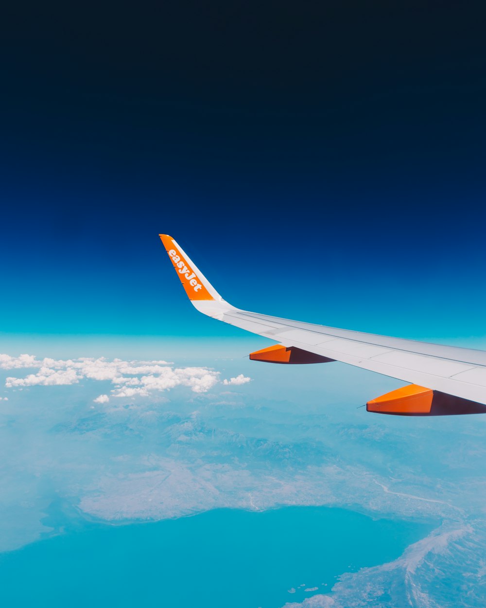 a view of the wing of an airplane in the sky