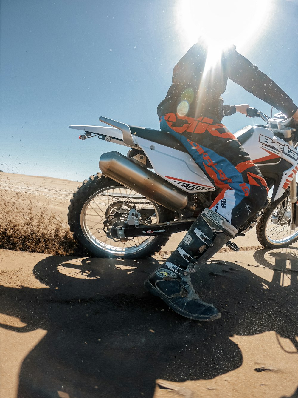 a man riding a dirt bike on top of a dirt field