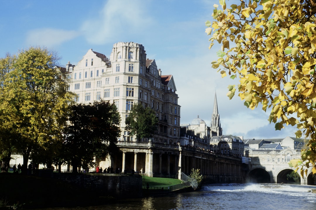 a river running through a city next to tall buildings,