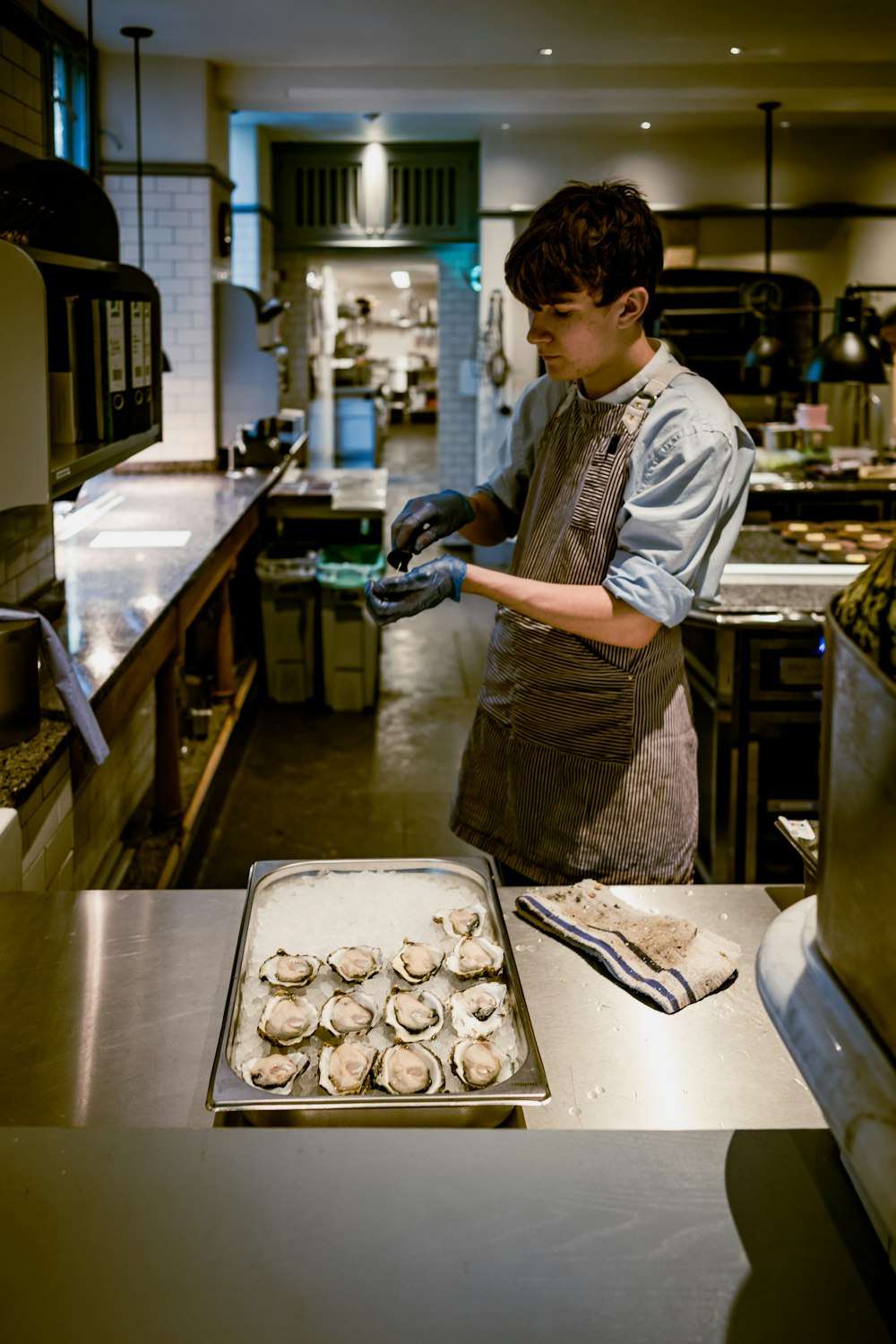 a man in a kitchen preparing food on a pan